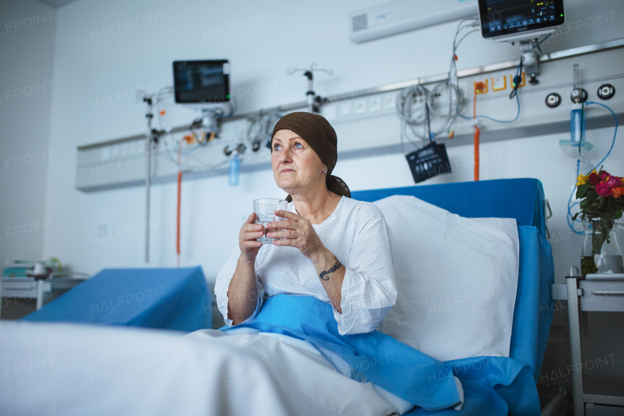 Senior woman sitting in hospital room after the chemotherapy.