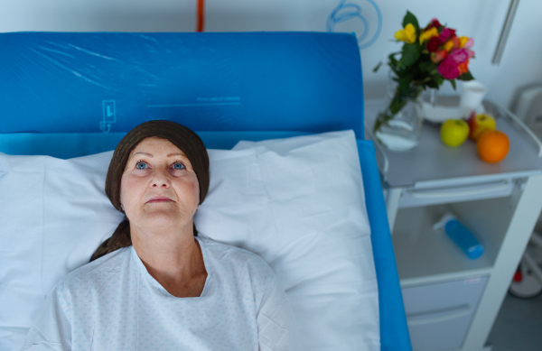 Senior woman lying in hospital room after the chemotherapy.