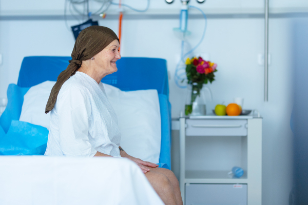 Senior woman sitting in hospital room after the chemotherapy.