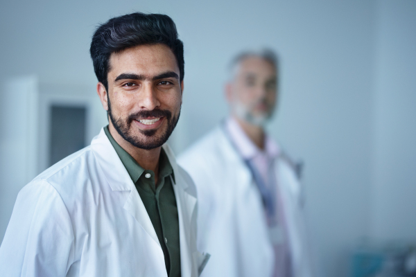 Portrait of happy young doctor at a hospital room.