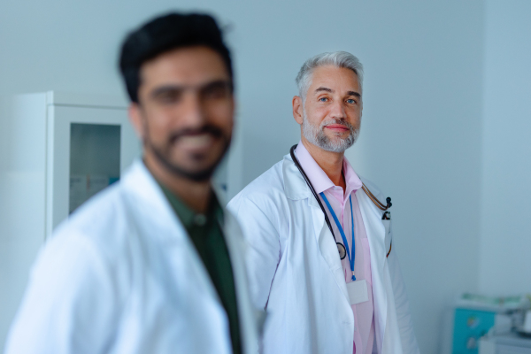 Portrait of happy mature doctor at a hospital room.