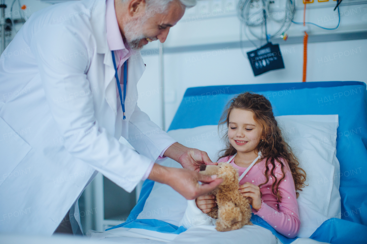 Happy doctor taking care and playing with a little girl.