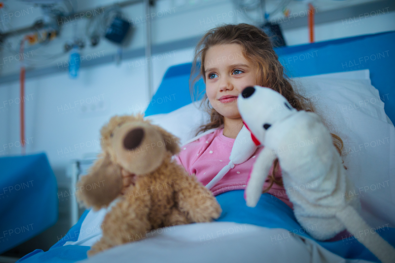 Portrait of little girl in a hospital room with her toys.