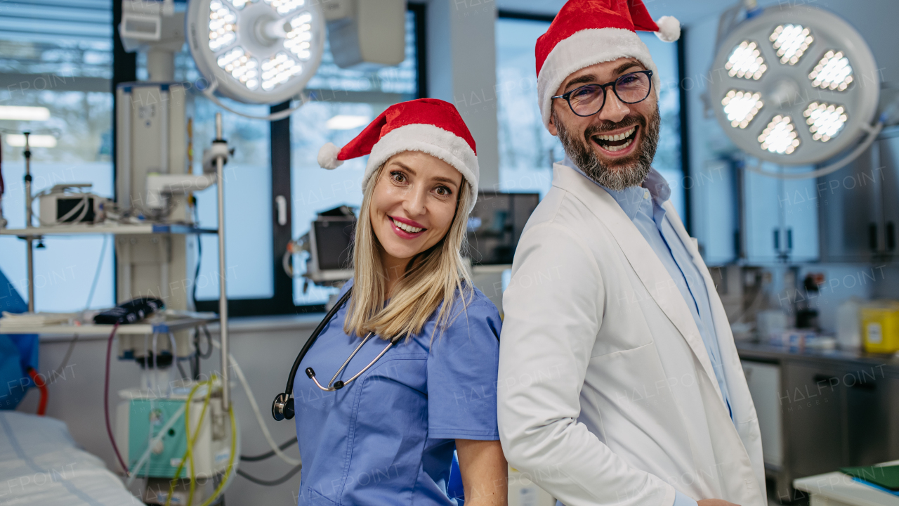 Medical emergency team during Christmas with Santa hat on head. Team of doctors and nurses working a Christmas shift in the hospital, hospital staff can't be with family during the Christmas Day and Christmas Eve.