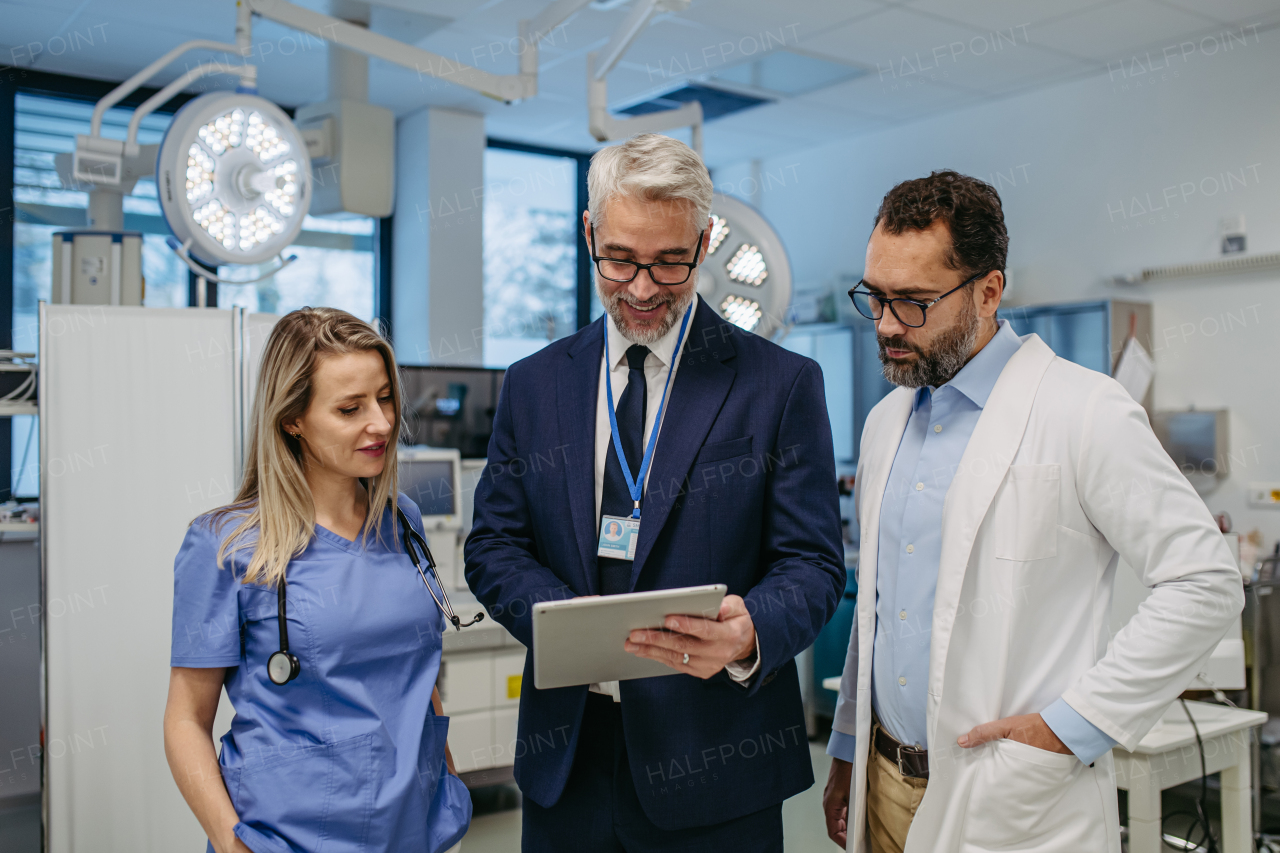 Portrait of pharmaceutical sales representative standing in doctor office. Hospital director, manager of private medical clinic greeting new doctors. Generous donor, giving donation to hospital. Through door.