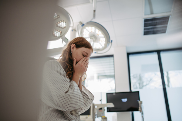 Close up of scared teenage patient, waitng for test results. Anxiety, worry and loneliness of teenager in hospital. Emotional support for ill young girl.