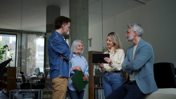 Businessman giving a presentation in a business meeting. Young colleagues and manager having casual discussion during meeting, workshop in office.