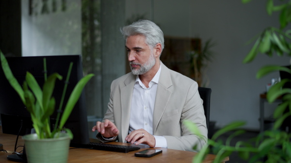 A video of male succesfull business leader working in his office.