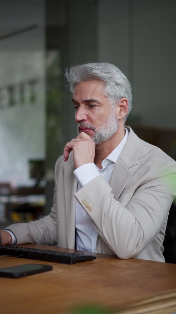 A video of male succesfull business leader working in his office.