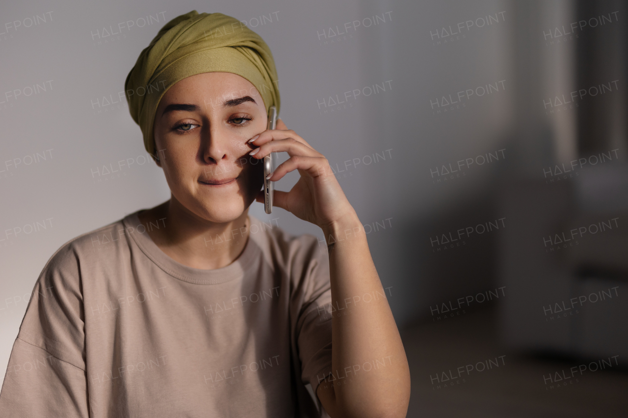 Young woman with a scarf on head calling.