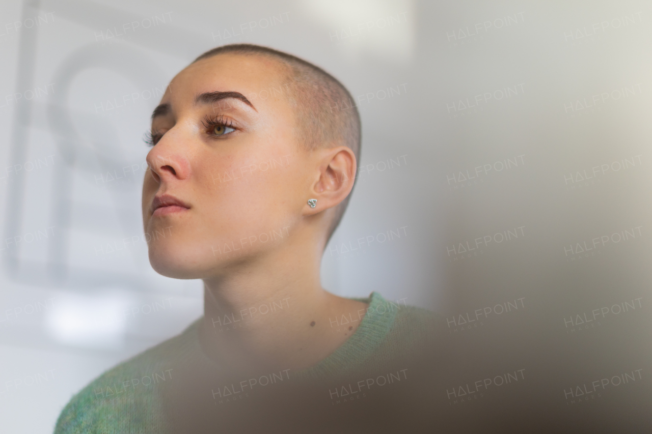 A portrait of unhappy pensive woman with cancer.