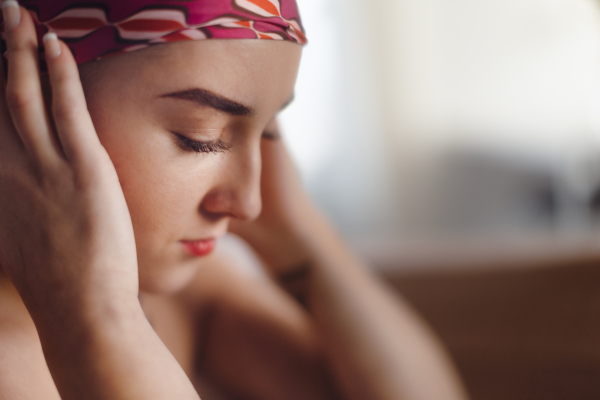 A portrait of unhappy pensive woman with cancer.