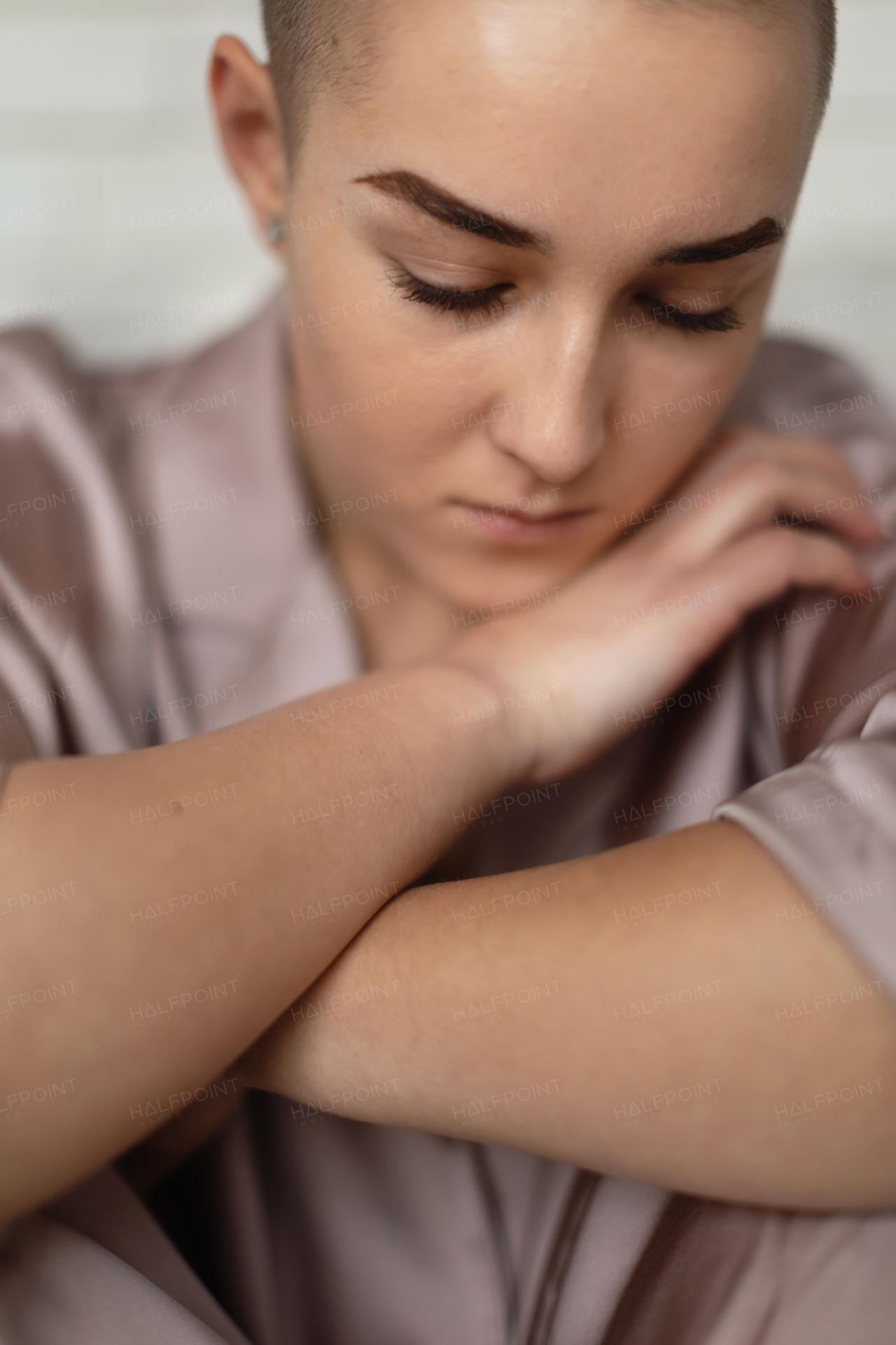 A portrait of unhappy pensive woman with cancer.