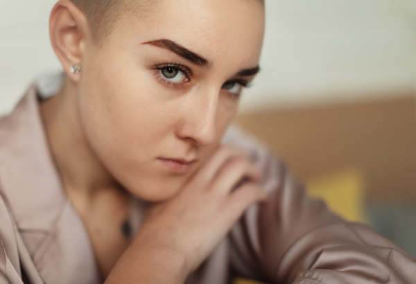 A portrait of unhappy pensive woman with cancer.