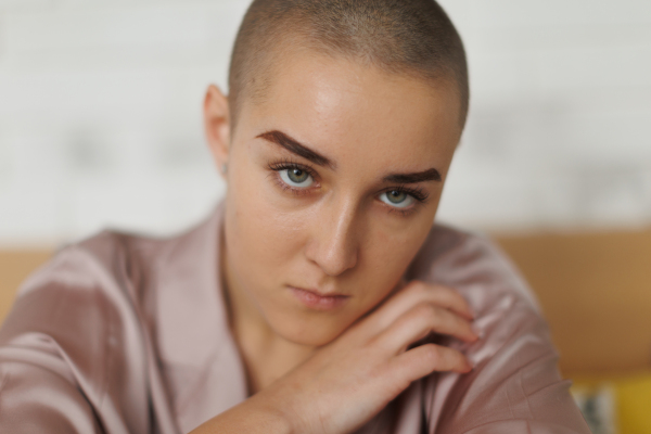 A portrait of unhappy pensive woman with cancer.