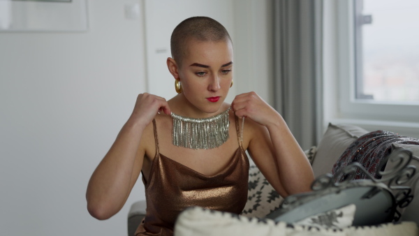 A Video of unhappy pensive woman with cancer, trying on necklace.