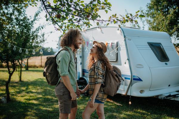 Young couple is on a camping trip in nature. Caravan traveling for young people