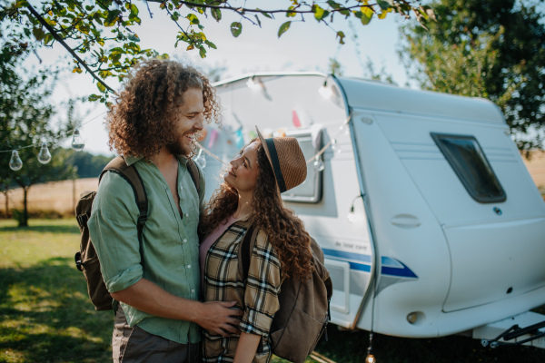 Young couple is on a camping trip in nature. Caravan traveling for young people