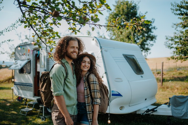 Young couple is on a camping trip in nature. Caravan traveling for young people