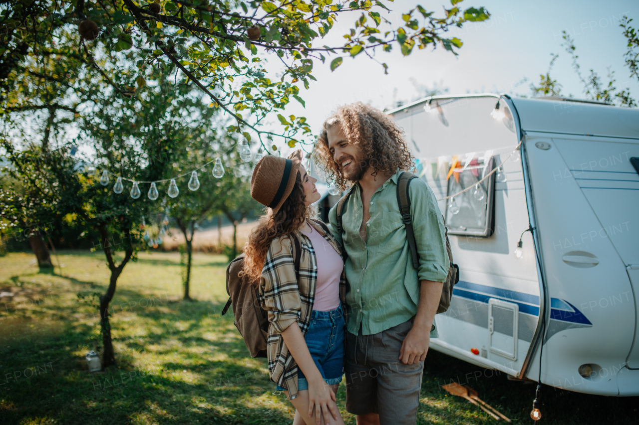 Young couple is on a camping trip in nature. Caravan traveling for young people