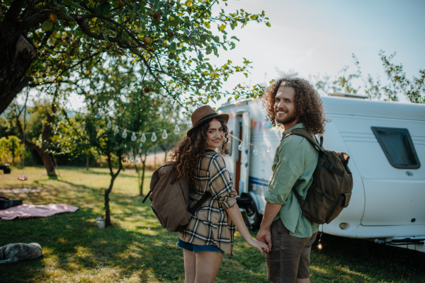 Young couple is on a camping trip in nature. Caravan traveling for young people