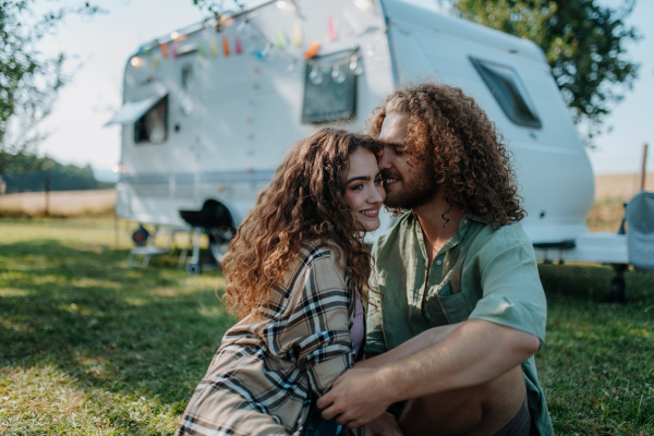 Young couple is on a camping trip in nature. Caravan traveling for young people