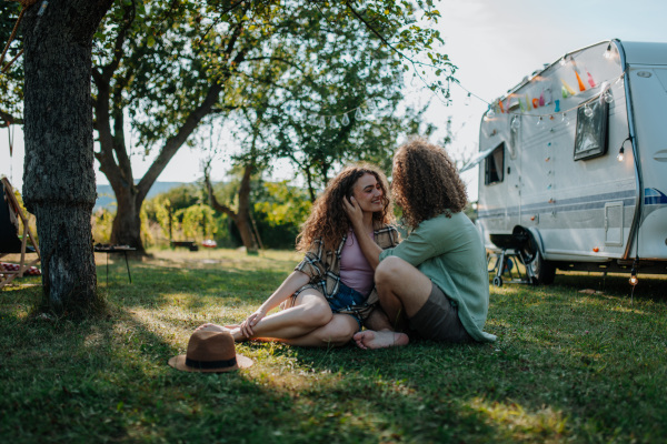 Young couple is on a camping trip in nature. Caravan traveling for young people