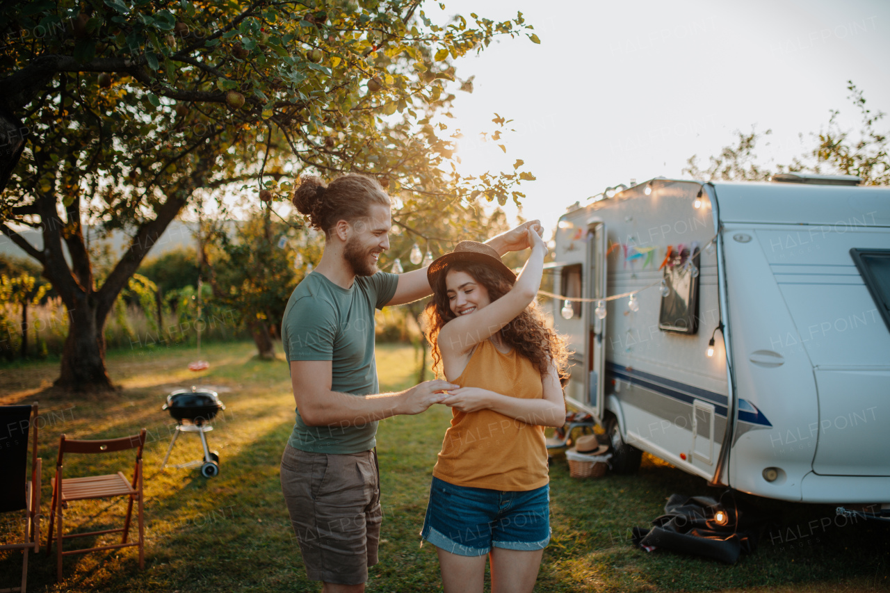 Young couple is on a camping trip in nature. Caravan traveling for young people