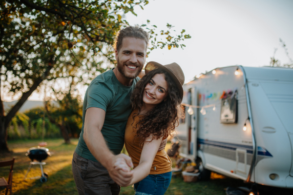 Young couple is on a camping trip in nature. Caravan traveling for young people