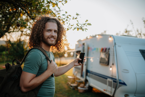 Young man is on a camping trip in nature alone. Caravan traveling for young people