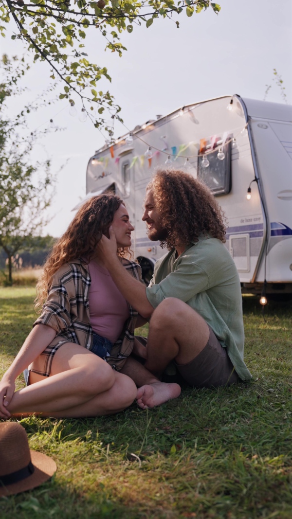 Young couple in love on a roadtrip with a caravan, camping and exploring new places