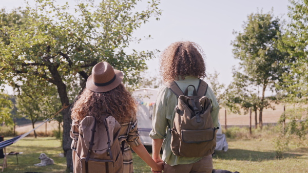 Young couple in love on a roadtrip with a caravan, camping and exploring new places.