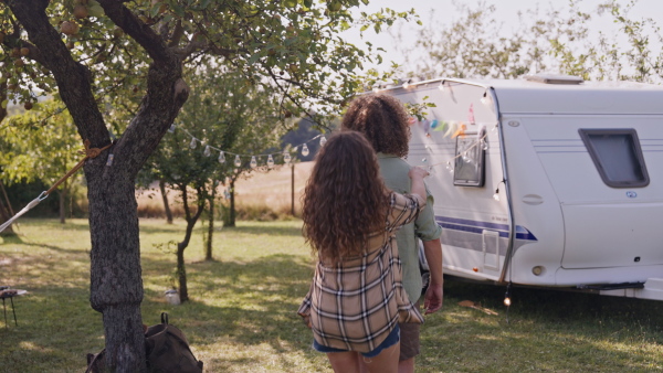 Young couple in love on a roadtrip with a caravan, camping and exploring new places.