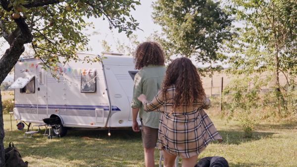 Young couple in love on a roadtrip with a caravan, camping and exploring new places.