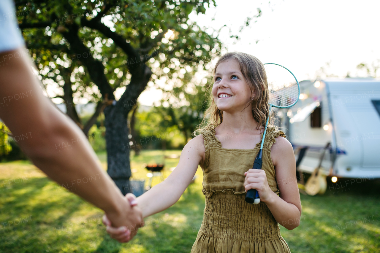 Brother and sister shaking hands after bedminton match.