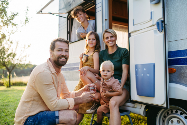 Portrait of family in caravan during their camping trip. Family roadtrip in caravan.