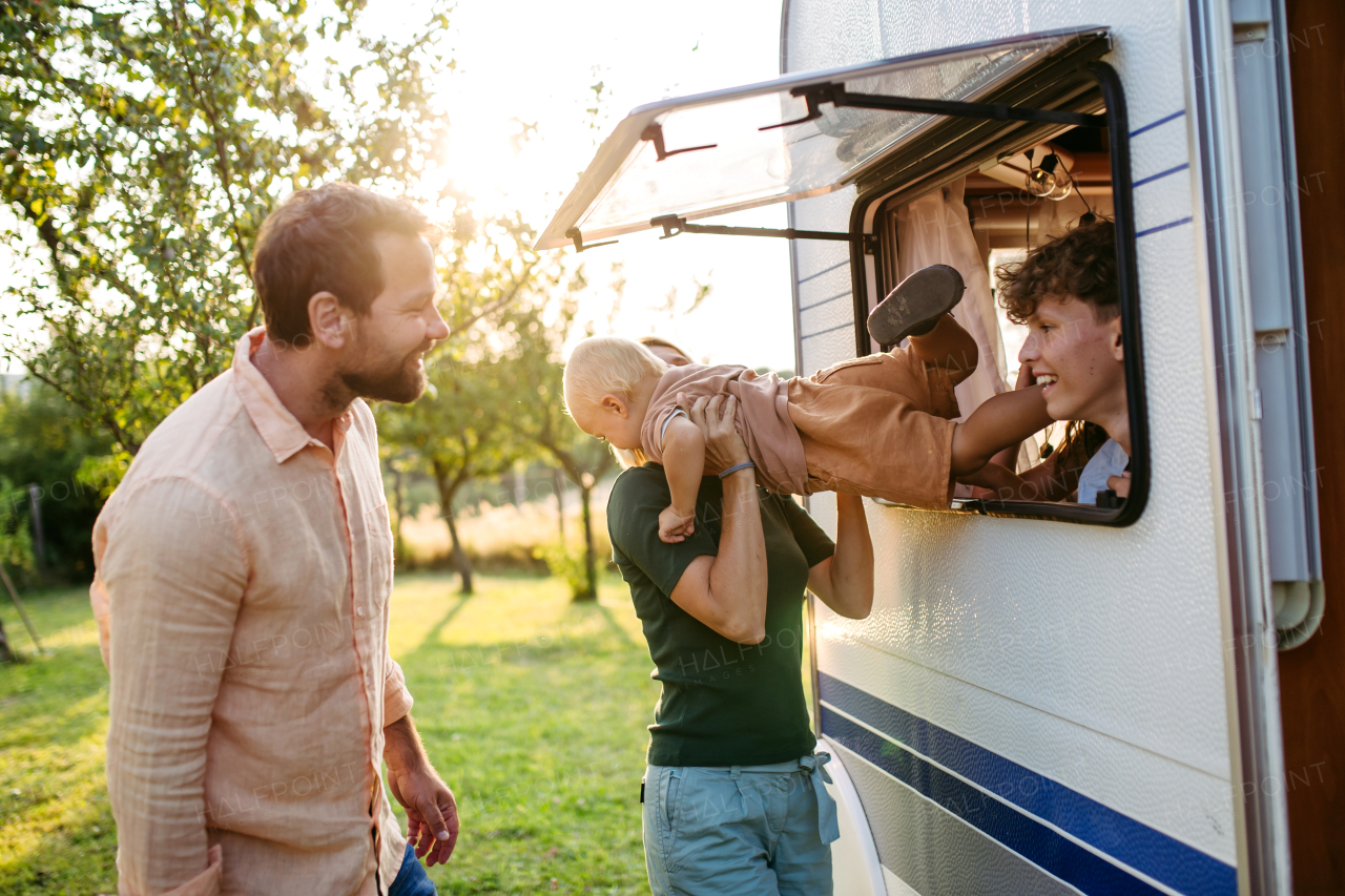 Portrait of family in caravan during their camping trip. Family roadtrip in caravan.