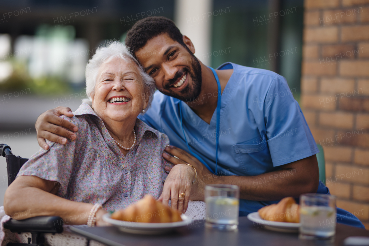 Caregiver having breakfast with his client at a cafe.