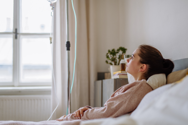 Teenage girl lying in the hospital bed.