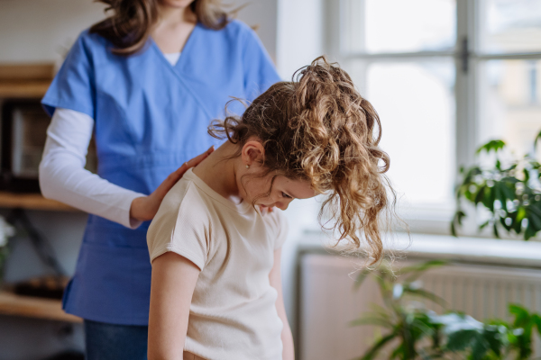 Little girl doing exercise with a physiotherapist.