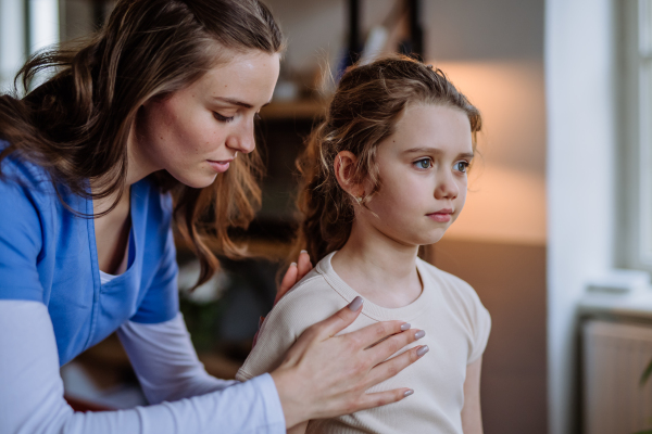 Little girl doing exercise with a physiotherapist.