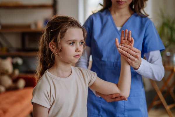 Little girl doing exercise with a physiotherapist.