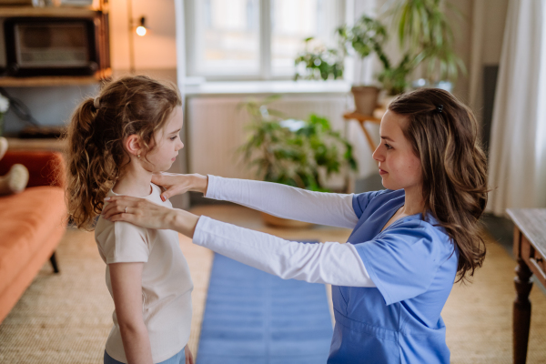 Little girl doing exercise with a physiotherapist.