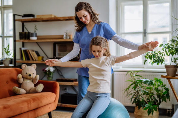 Little girl doing exercise with a physiotherapist.