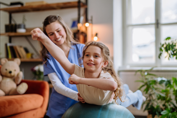 Little girl doing exercise with a physiotherapist.