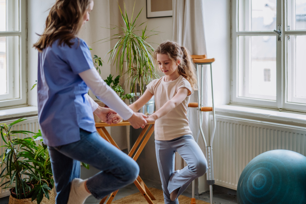 Little girl doing exercise with a physiotherapist.