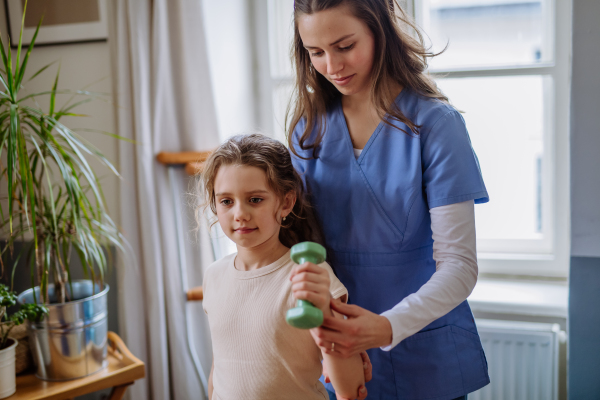 Little girl doing exercise with a physiotherapist.