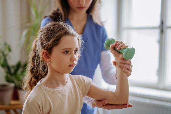 Little girl doing exercise with a physiotherapist.