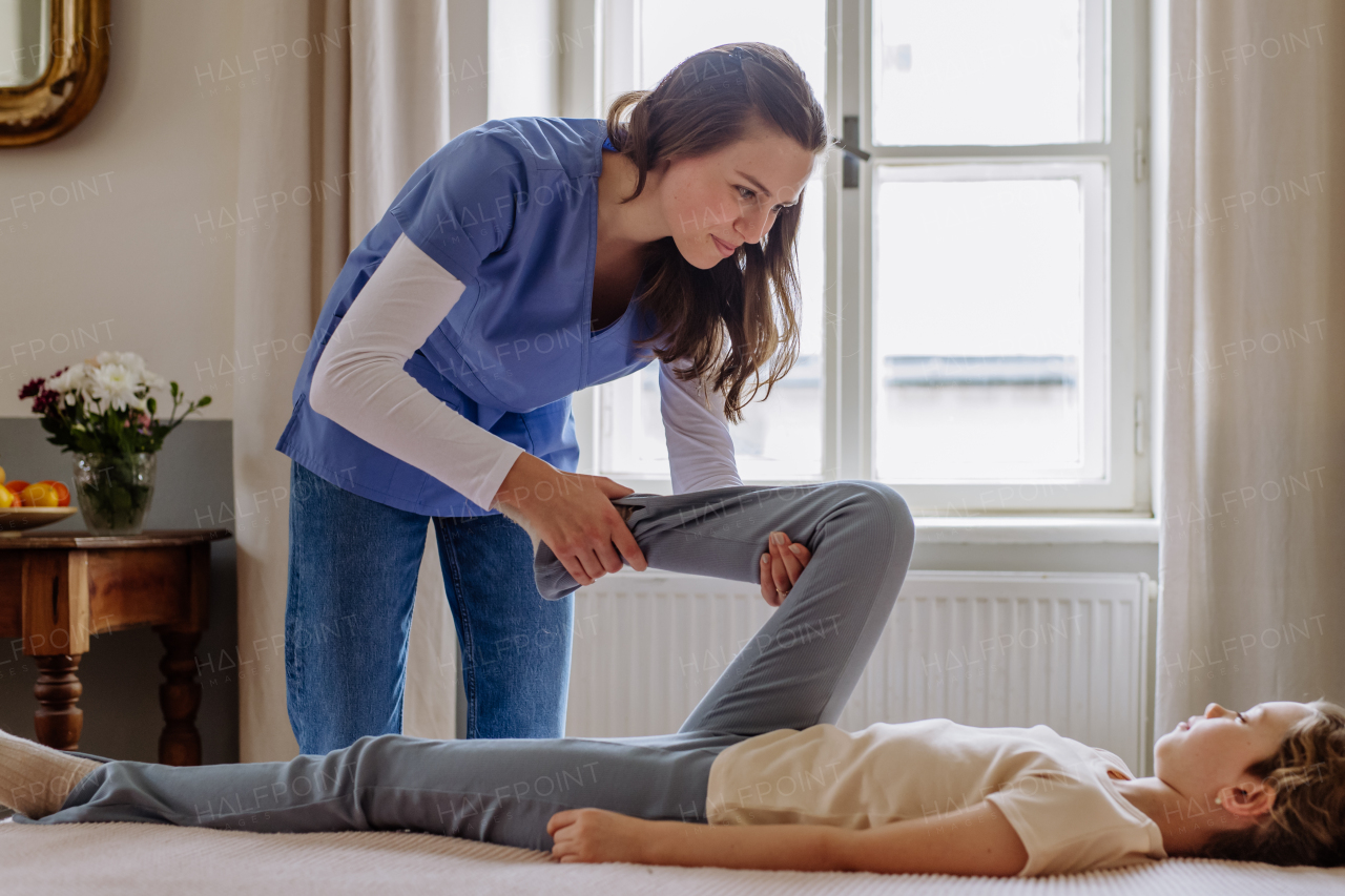 Little girl doing exercise with a physiotherapist.