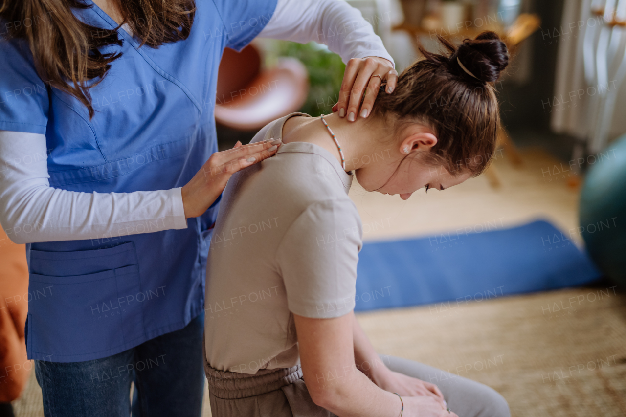 Teenage girl doing exercise with a physiotherapist.